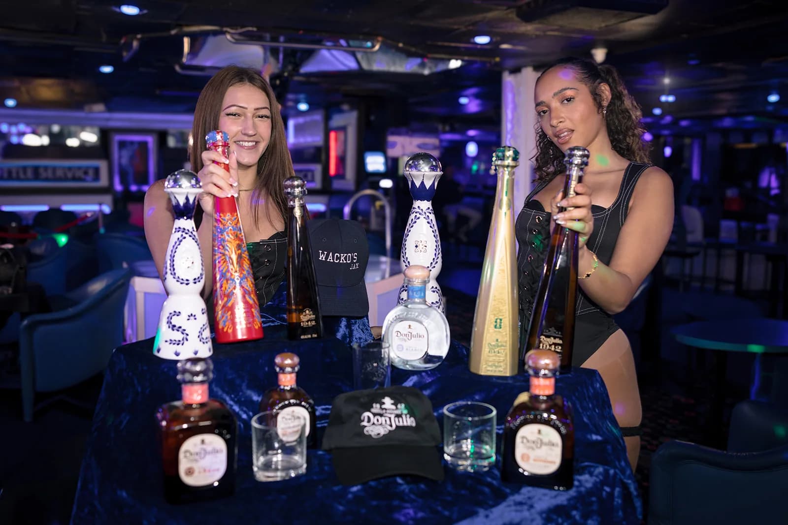 Wacko's performers presenting bottle-service selections in the lounge